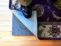 A felt rug pad adds body and protects your floor from grit and abrasion.  Felt rug pads are like shock-absorbers, and extend the life of your rug.